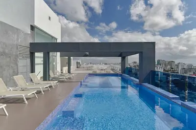 a swimming pool on the roof of a building at S802 Lujoso Apartamento Downtown Santo Domingo RD in Santo Domingo