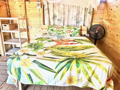a bedroom with two beds with flowers on it at Beach Terrace Loft in Buen Hombre in Buen Hombre