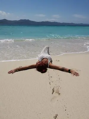 a woman laying in the sand on the beach at Beach Terrace Loft in Buen Hombre in Buen Hombre