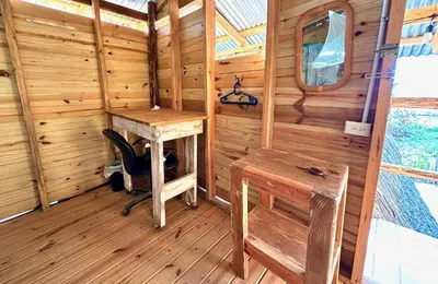 a wooden cabin with a desk and a chair in it at Beach Terrace Loft in Buen Hombre in Buen Hombre