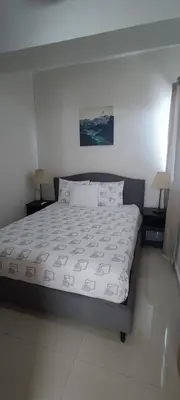 a large bed in a bedroom with two lamps at Boca del Mar Residence, Boca Chica in Boca Chica
