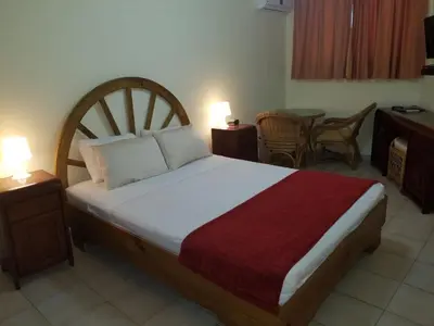 a bedroom with a bed and a table and chairs at Hotel Plaza Europa in Sosúa
