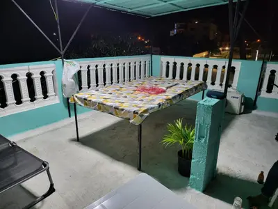a bench sitting on a balcony at night at SUISSE . CH APPARTEMENT in San Pedro de Macorís