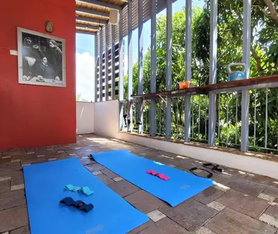 a room with two blue yoga mats in front of a window at Heritage Residences Signature Collection in Santo Domingo
