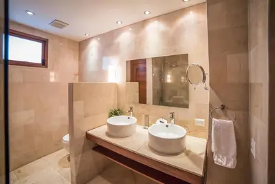 a bathroom with a sink and a mirror at Heritage Residences Signature Collection in Santo Domingo