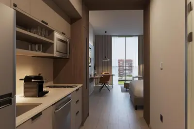 a kitchen with a counter and a table in a room at Residence Inn by Marriott Santiago de los Caballeros in Santiago de los Caballeros