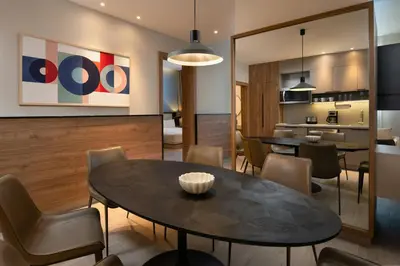 a dining room and kitchen with a table and chairs at Residence Inn by Marriott Santiago de los Caballeros in Santiago de los Caballeros