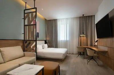 a hotel room with a couch and a bed and a desk at Residence Inn by Marriott Santiago de los Caballeros in Santiago de los Caballeros