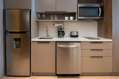 a kitchen with a stainless steel refrigerator and microwave at Residence Inn by Marriott Santiago de los Caballeros in Santiago de los Caballeros