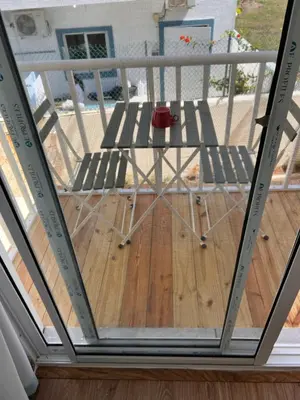 a screened porch with a chair on a deck at EMY HOUSE in La Laguna