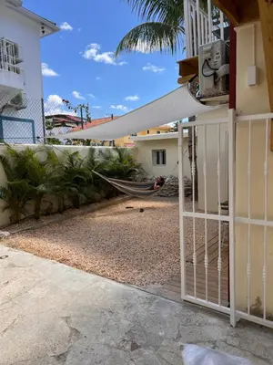 a hammock is tied to a house with a fence at EMY HOUSE in La Laguna