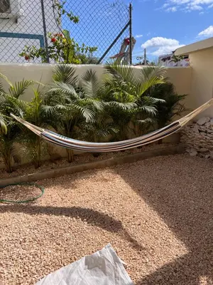 a hammock sitting next to a fence with plants at EMY HOUSE in La Laguna