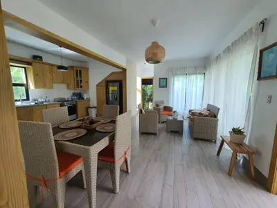 a kitchen and living room with a table and chairs at Villa María Victoria, en Jarabacoa in Jarabacoa