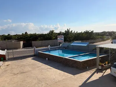 a swimming pool on the roof of a building at Hotel Vista al Morro in San Fernando de Monte Cristi
