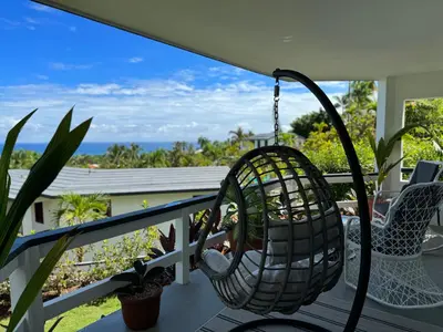 a porch with a swing and two chairs at Catalina, Cabrera Oceanview Multi 2 BD 2 Bath Condo Units with Balcony and Pool in Caño Seco