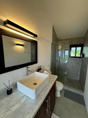 a bathroom with a white sink and a shower at Catalina, Cabrera Oceanview Multi 2 BD 2 Bath Condo Units with Balcony and Pool in Caño Seco