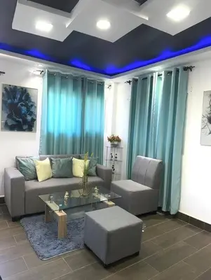 a living room with a couch and a table at JC Caribe Aparta Hotel #1 in La Caleta