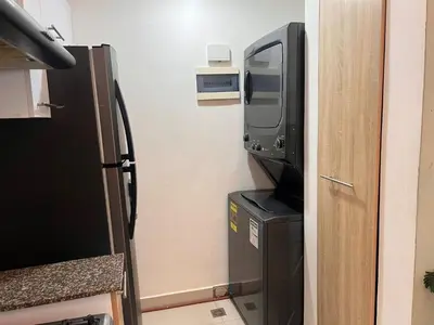 a television and a refrigerator in a room at Perfecto para 3 personas. in Boca Chica