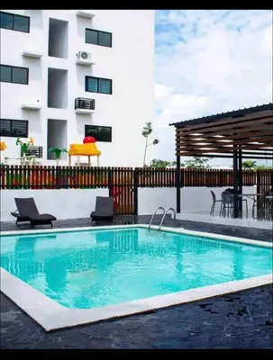 a swimming pool in front of a building at Estudio privado con vigilancia 24/7 con entrada independiente, in Santiago de los Caballeros