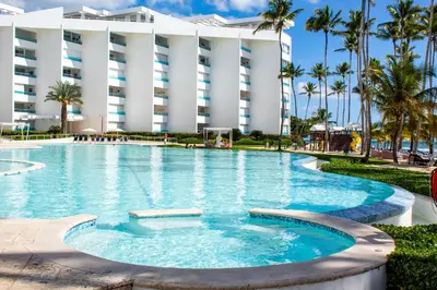 a large swimming pool in front of a building at Marbella Juan Dolio Beachfront in Juan Dolio