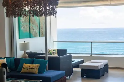 a living room with a view of the ocean at Marbella Juan Dolio Beachfront in Juan Dolio