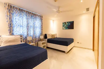 a bedroom with two beds and a window at Marbella Juan Dolio Beachfront in Juan Dolio