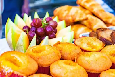 a plate of food with grapes and donuts and bread at Exclusive Villa * private Beach and Housekeeping in Punta Cana