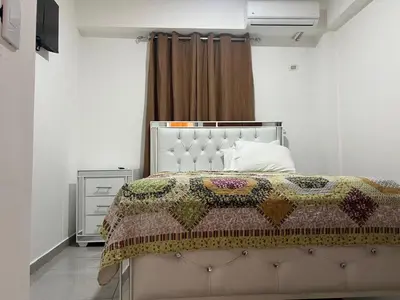 a bedroom with a bed with a quilt on it at HABITACIONES CON VISTA a LA BAHIA LA FAMILIA in Santa Bárbara de Samaná