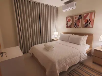a bedroom with a white bed and a window at Escapada en Boca chica in Boca Chica