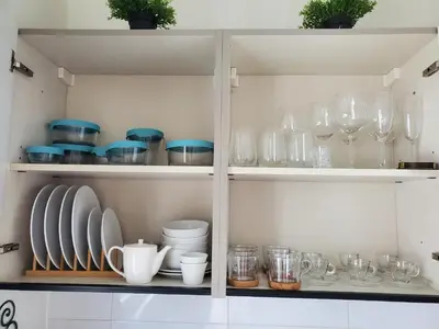 a cupboard filled with glasses and plates and dishes at Escapada en Boca chica in Boca Chica