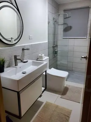a bathroom with a sink and a toilet and a mirror at Escapada en Boca chica in Boca Chica