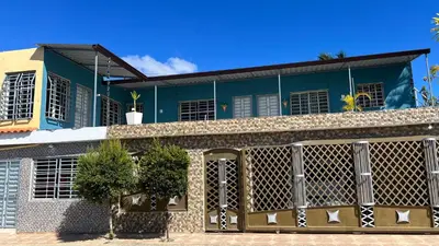 a blue building with a fence in front of it at SDQ Apartamento Marbella 3 in La Ureña