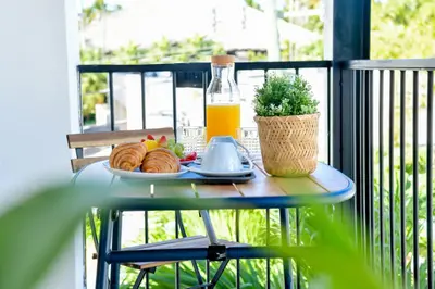 a table with a plate of food and a bottle of orange juice at Honky Tonk Punta Cana in Punta Cana