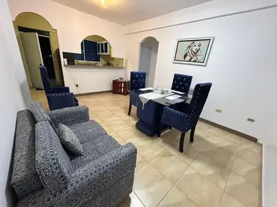 a living room with a couch and a table and chairs at Apartamento pisó 1 parqueo, piscina, terraza y más in Azua de Compostela