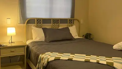 a bedroom with a bed and a lamp and a window at Hotel Plaza Kavia in Santo Domingo