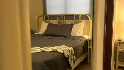 a bedroom with a bed with a metal headboard at Hotel Plaza Kavia in Santo Domingo