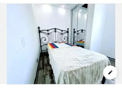 a bedroom with a bed and a large mirror at JC caribe Aparta Hotel #7 in Boca Chica