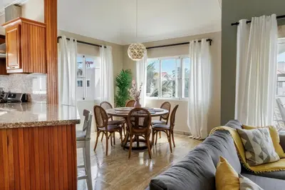 a kitchen and dining room with a couch and a table at Corte Sea A302, Luxury Penthouse in Punta Cana