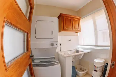 a small kitchen with a white refrigerator at Corte Sea A302, Luxury Penthouse in Punta Cana