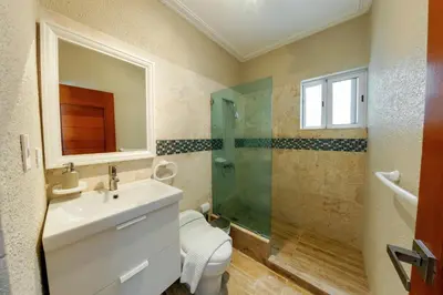 a bathroom with a toilet and a sink and a shower at Corte Sea A302, Luxury Penthouse in Punta Cana