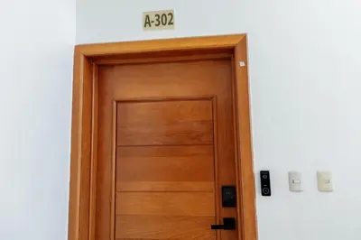 a wooden door in a room with a sign above it at Corte Sea A302, Luxury Penthouse in Punta Cana