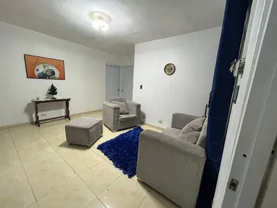 a living room with two couches and a blue rug at Casa en Villa Marchena azua in Azua de Compostela