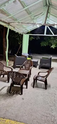 a group of benches sitting under a tent at Casa en Villa Marchena azua in Azua de Compostela
