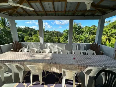 a large table and chairs on a patio at Country home in the hills of Samana in Santa Bárbara de Samaná
