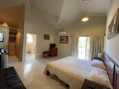 a bedroom with a bed and a television in it at Luxury Villa Classic style, 7 minutes from the beach in Sosua in San Felipe de Puerto Plata