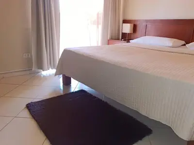 a bedroom with a large bed with a black rug at Luxury Villa Classic style, 7 minutes from the beach in Sosua in San Felipe de Puerto Plata