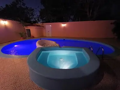 a jacuzzi tub in a backyard at night at Luxury Villa Classic style, 7 minutes from the beach in Sosua in San Felipe de Puerto Plata
