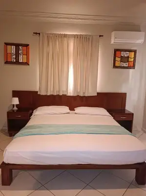 a bedroom with a large bed with a window at Luxury Villa Classic style, 7 minutes from the beach in Sosua in San Felipe de Puerto Plata