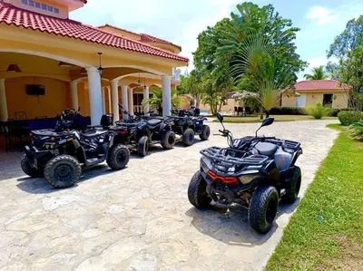 a row of four atvs parked in front of a house at Luxury Villa Classic style, 7 minutes from the beach in Sosua in San Felipe de Puerto Plata