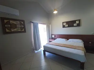 a bedroom with a large bed and a window at Luxury Villa Classic style, 7 minutes from the beach in Sosua in San Felipe de Puerto Plata